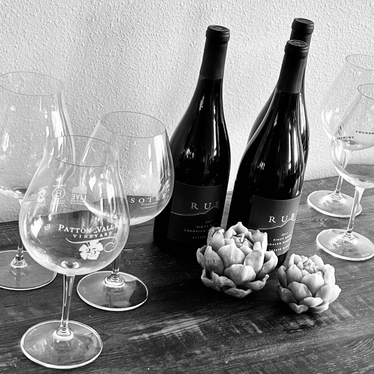 Oregon Pinot Noir bottles and glasses arranged for a private tasting